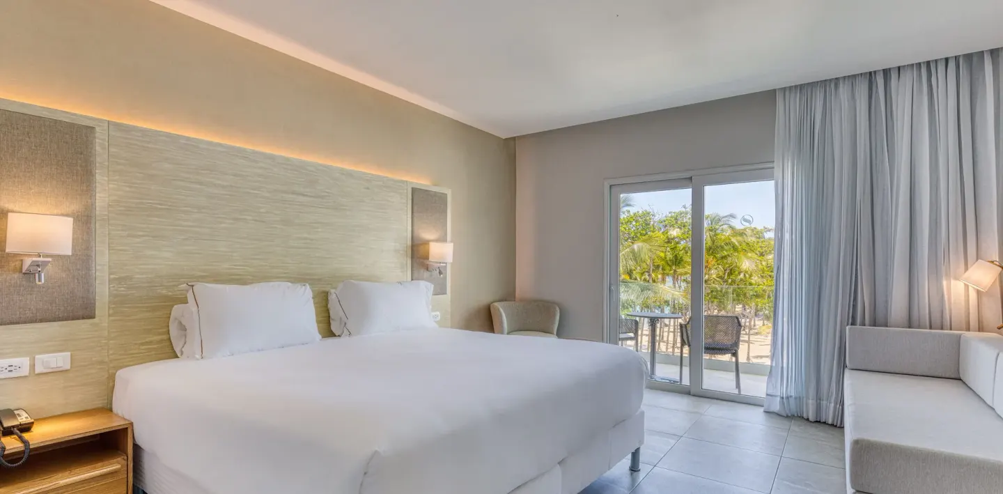 Ocean view junior suite with king bed and balcony at Senator Puerto Plata.