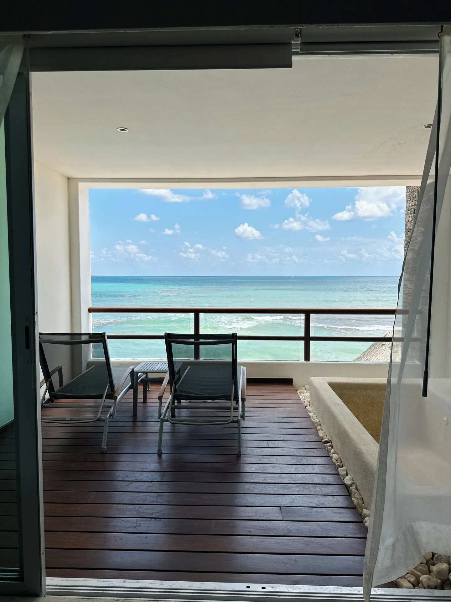 Balcony lounge chairs and soaking tub face the sea at Senses Riviera Maya Oceanfront.