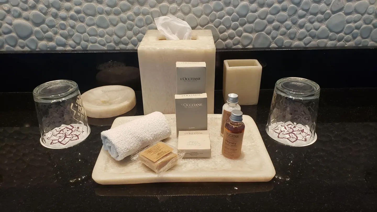 Bathroom amenities on a black vanity at Senses Riviera Maya Oceanfront.