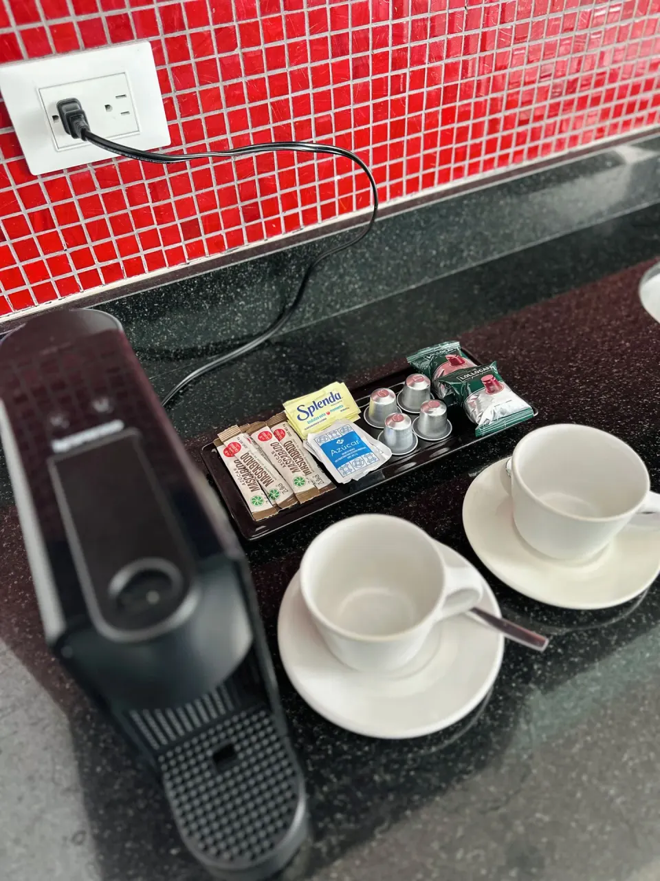 Coffee machine, cups, and supplies on a counter at Senses Riviera Maya Oceanfront.