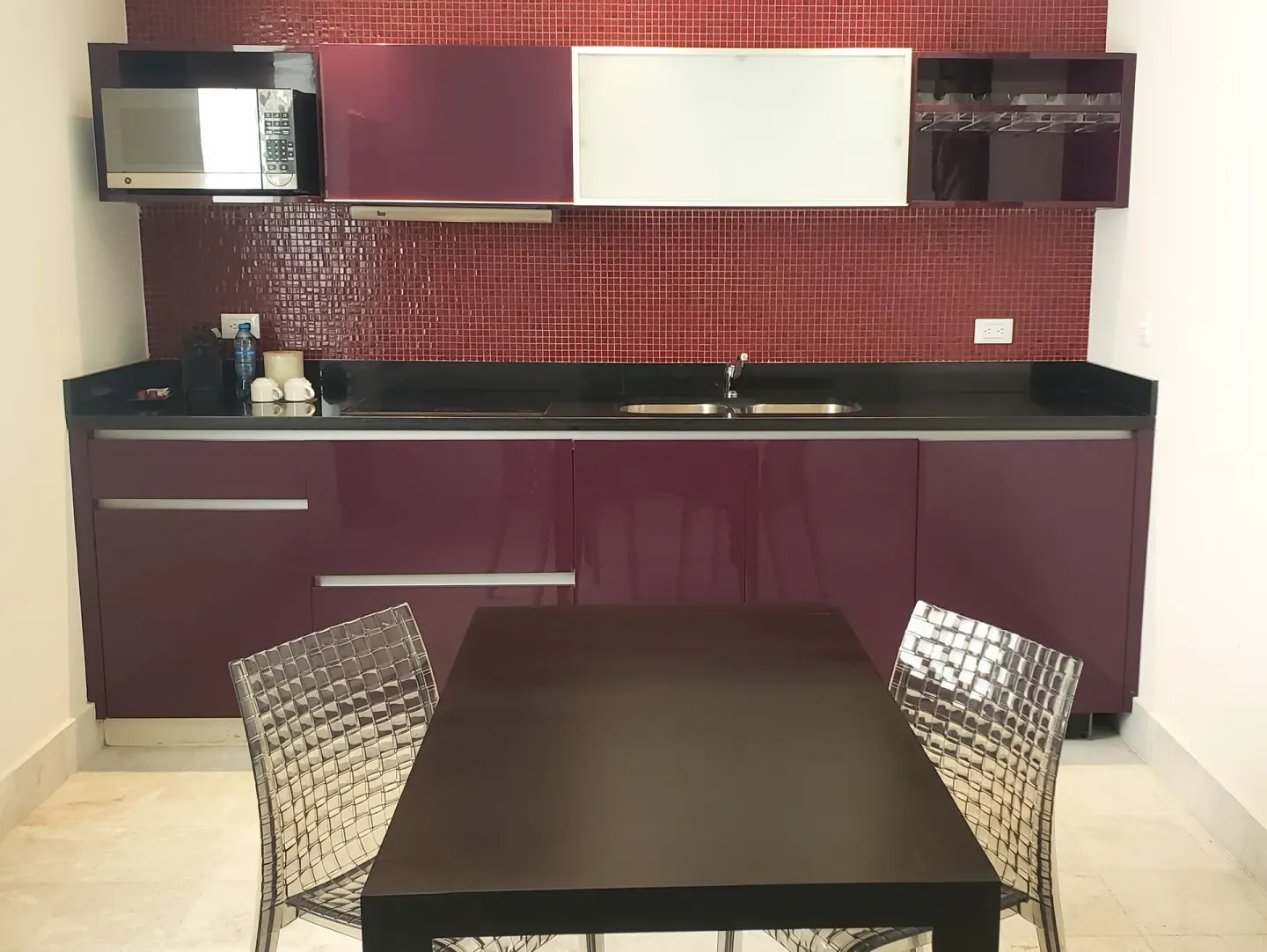 Guest room dining table and kitchenette at Senses Riviera Maya Oceanfront.