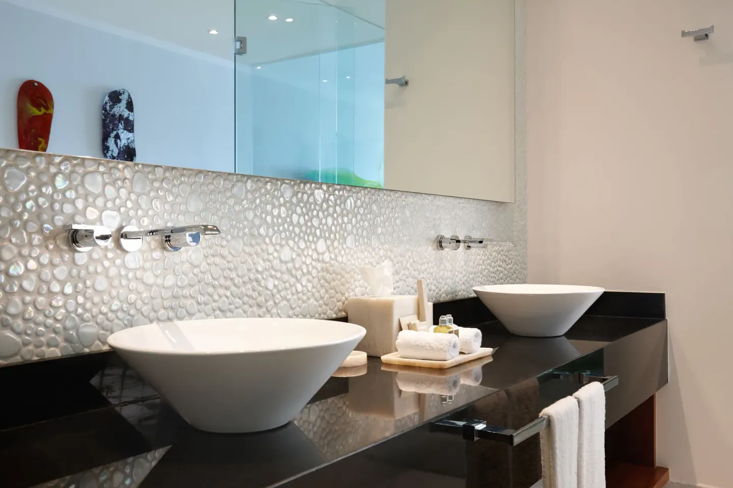 Double vessel sink vanity with pebble tile at Senses Riviera Maya Oceanfront.