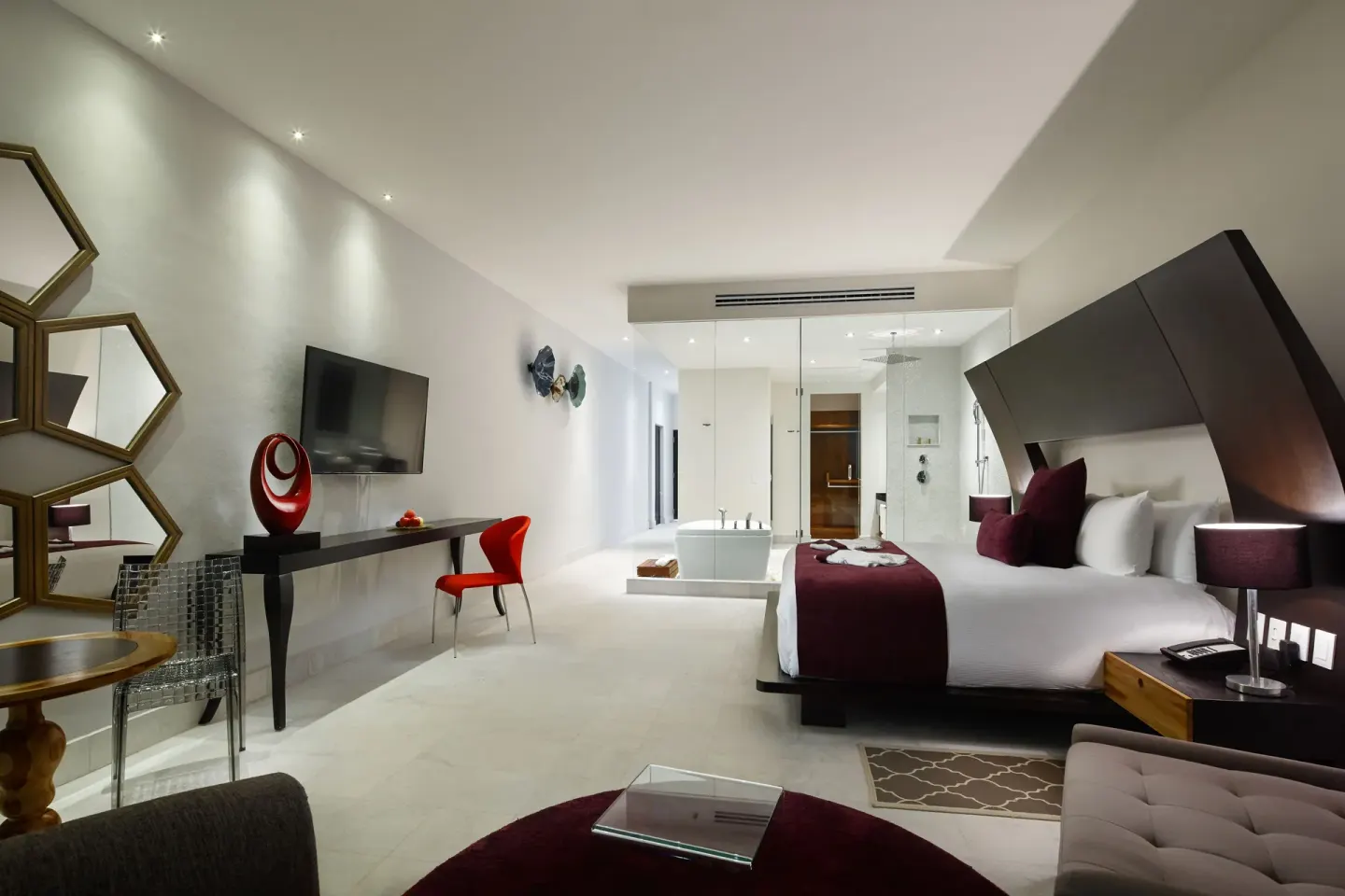 Guest room with king bed and glass-walled bath at Senses Riviera Maya Oceanfront.