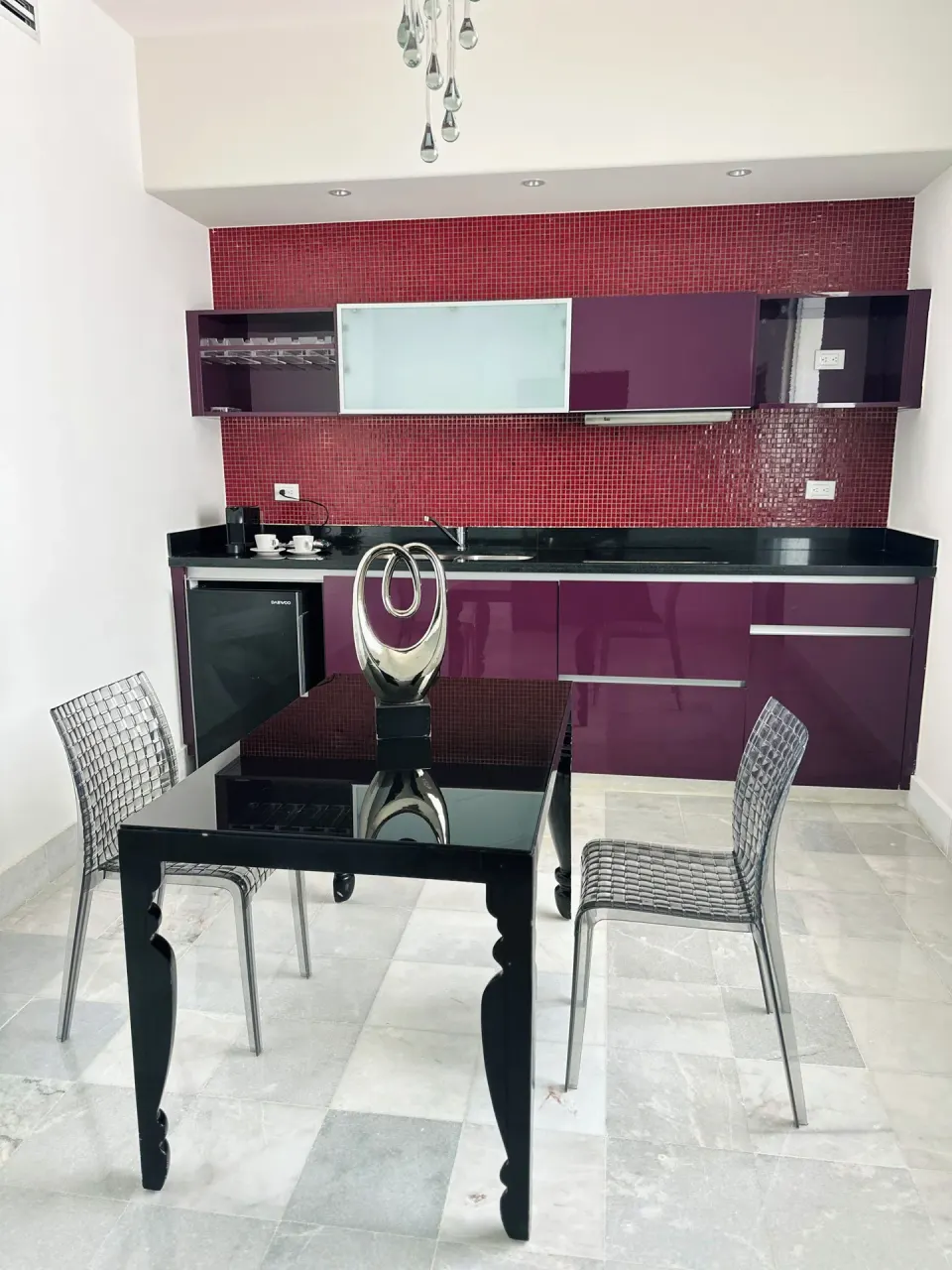 Guest room kitchenette and glass dining table at Senses Riviera Maya Oceanfront.