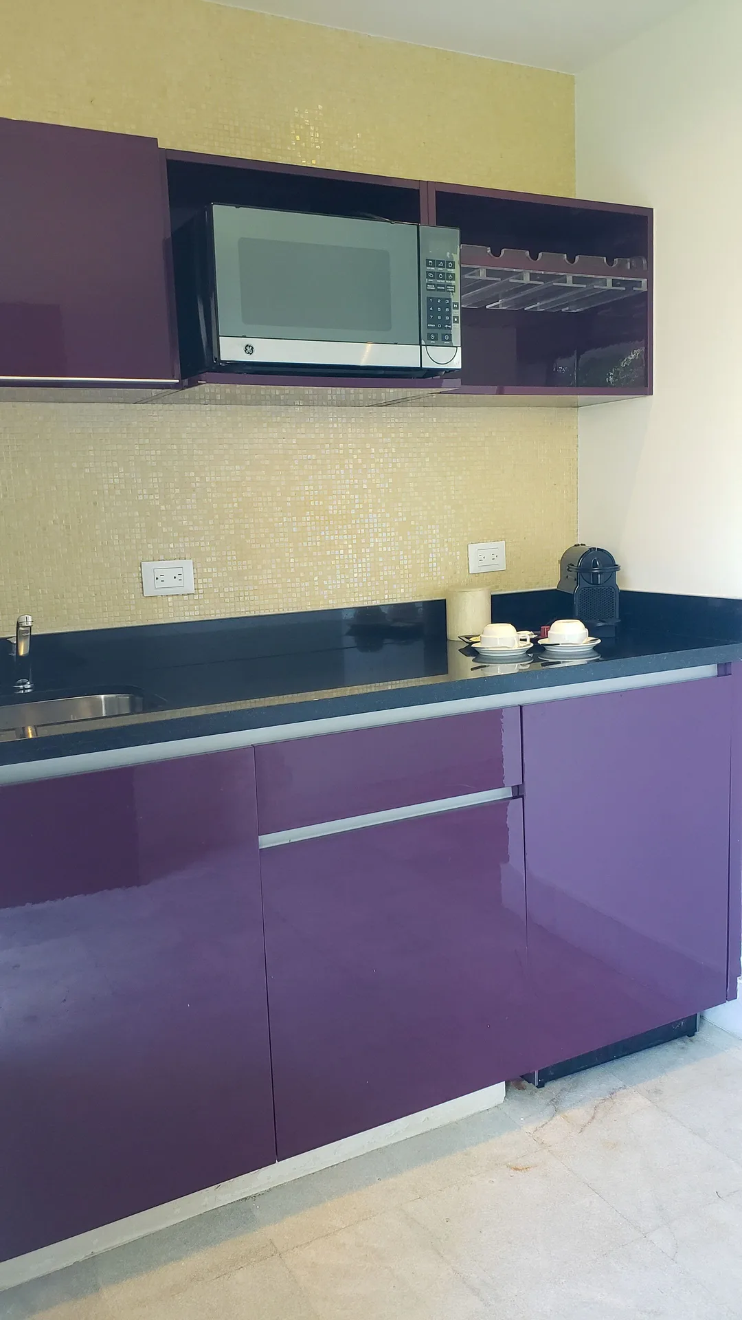 Guest room kitchenette with purple cabinets at Senses Riviera Maya Oceanfront.