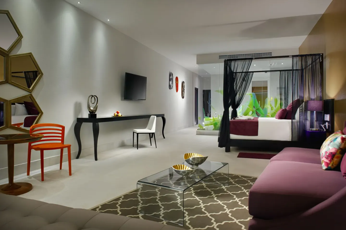 Guest room lounge with canopy king bed at Senses Riviera Maya Oceanfront.