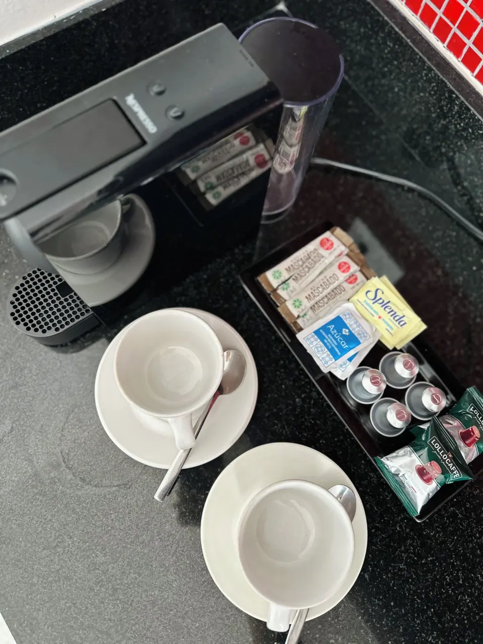 In-room coffee station with cups and capsules at Senses Riviera Maya Oceanfront.