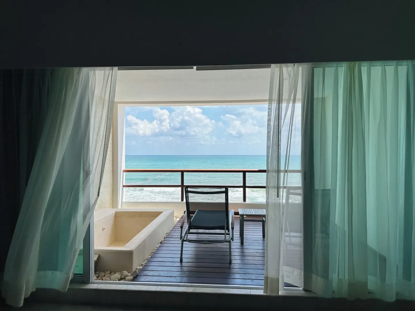 Guest room balcony with soaking tub and ocean view at Senses Riviera Maya Oceanfront.
