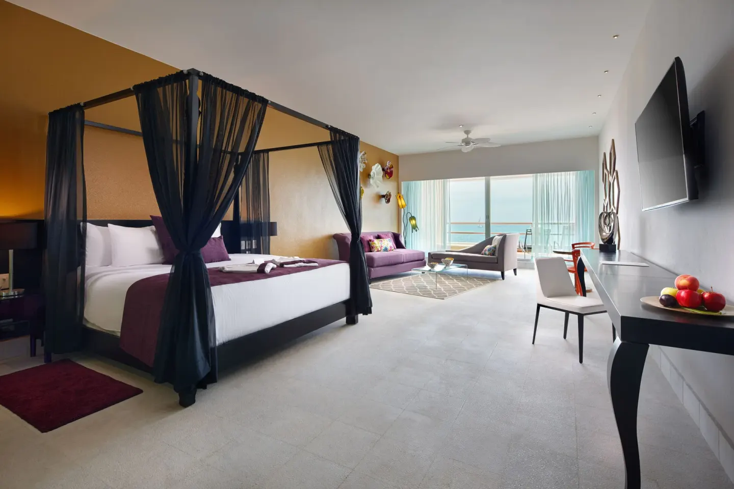 Ocean-view guest room with canopy king bed at Senses Riviera Maya Oceanfront.
