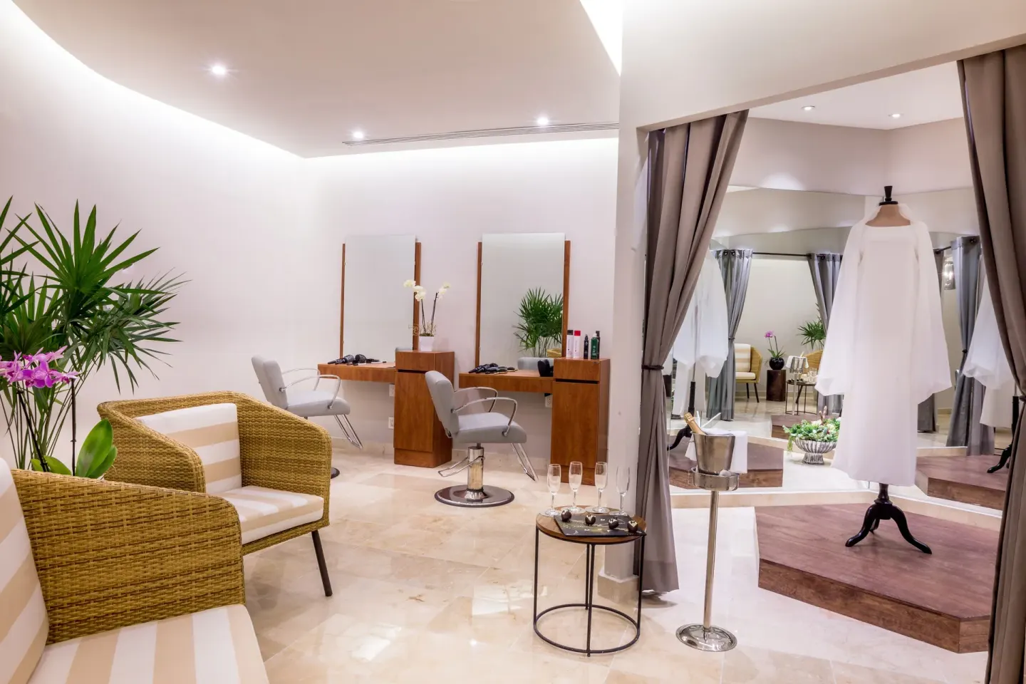 Bridal styling suite with salon chairs and a gown at Sensira Resort & Spa Riviera Maya.