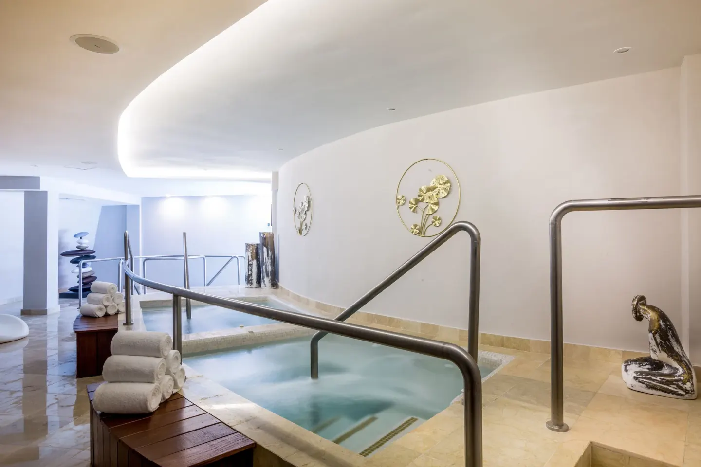 Hydrotherapy pool with handrails and stacked towels at Sensira Resort & Spa Riviera Maya.
