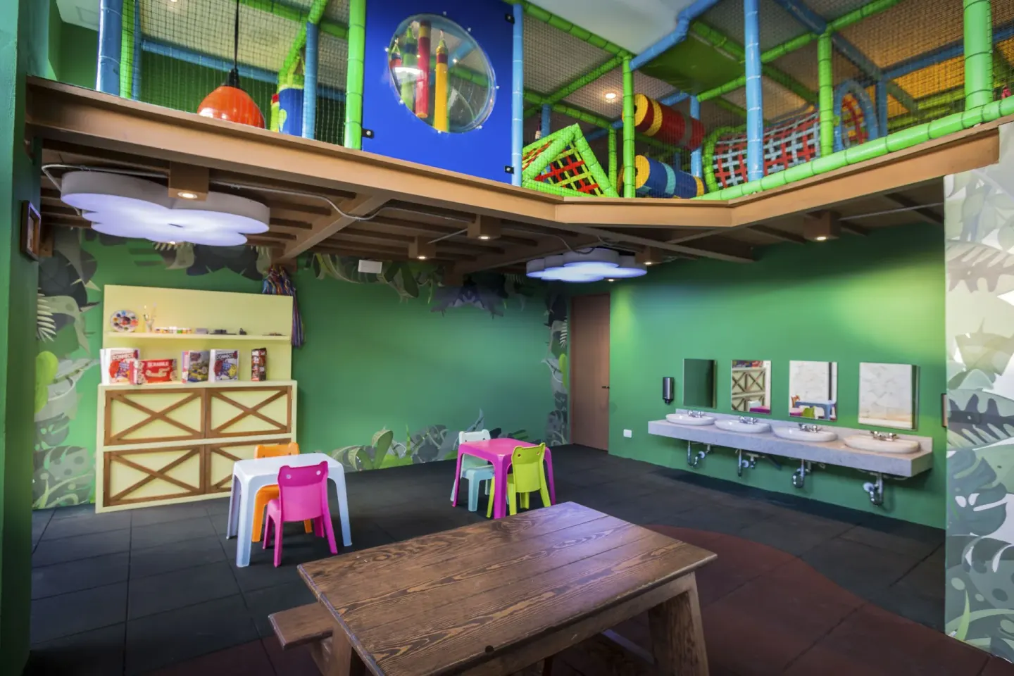 Kids club playroom with tables and sinks at Sensira Resort & Spa Riviera Maya.