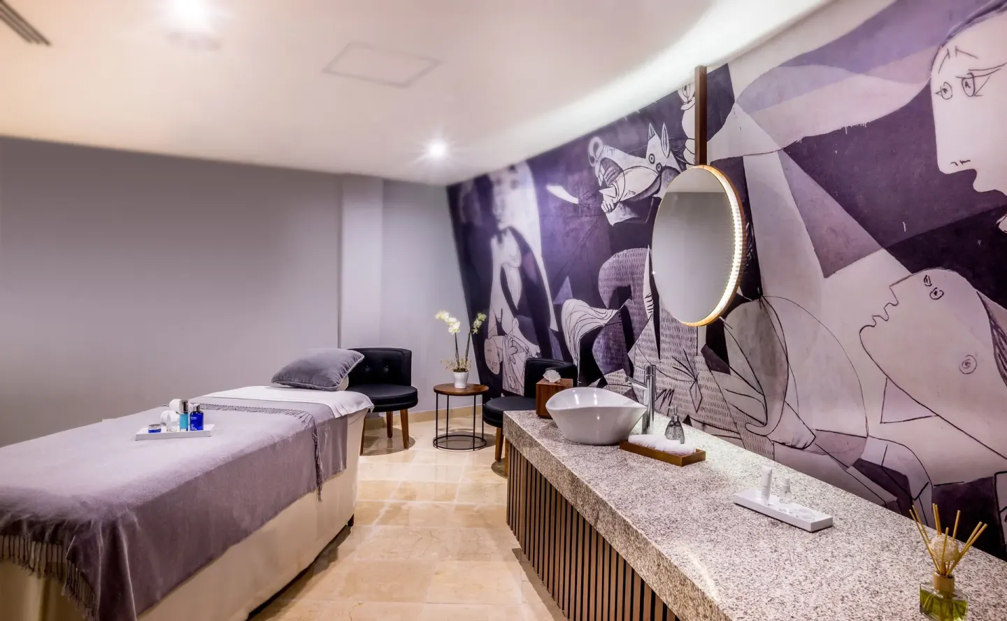 Massage treatment room with a mural wall at Sensira Resort & Spa Riviera Maya.