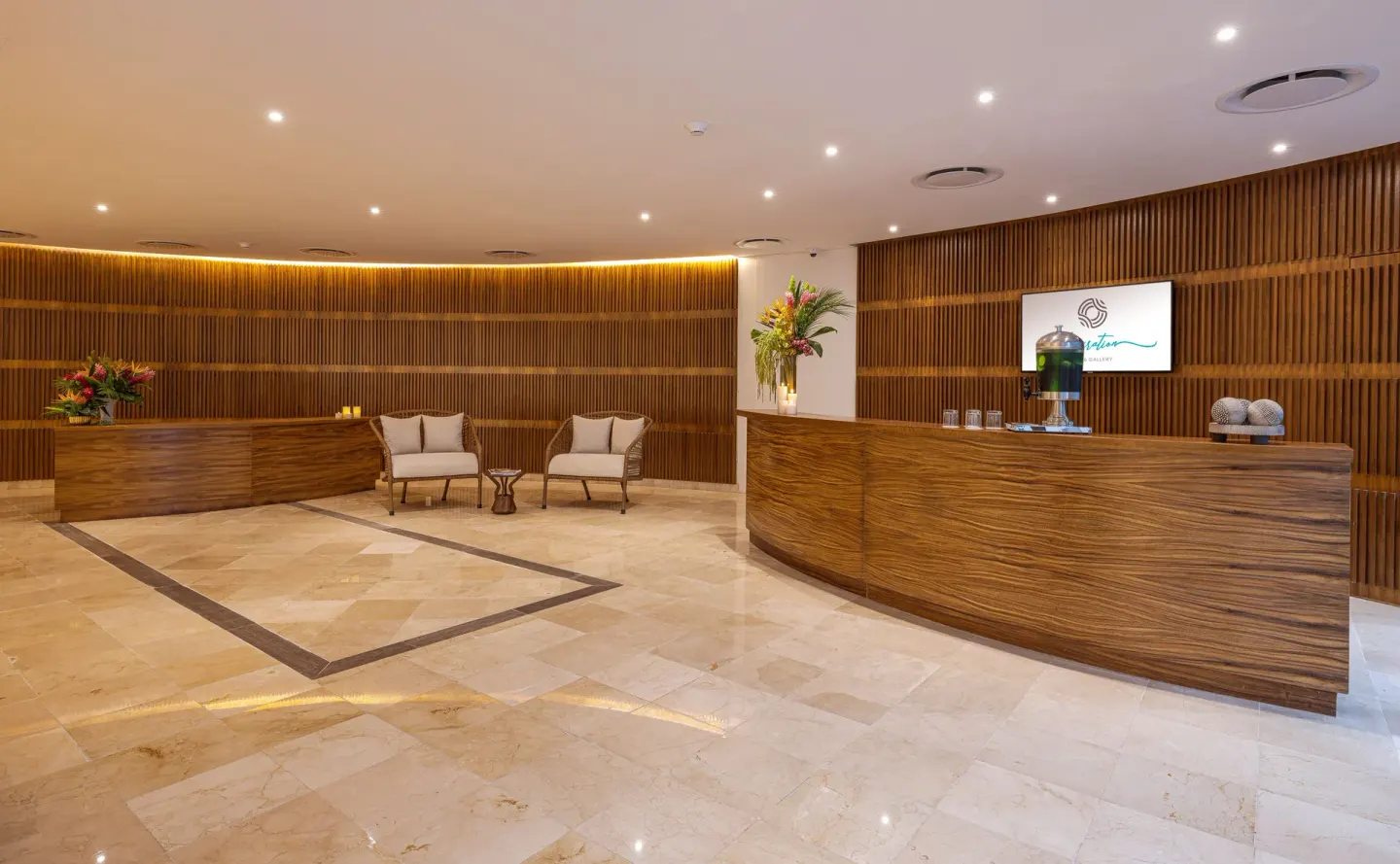 Spa reception with wood counters and seating at Sensira Resort & Spa Riviera Maya.