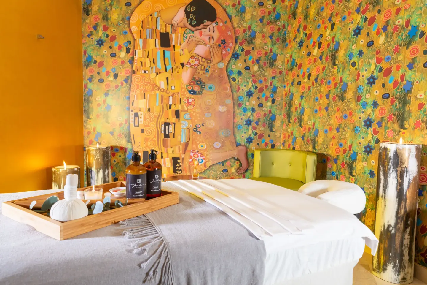 Spa treatment room with massage bed and colorful mural at Sensira Resort & Spa Riviera Maya.