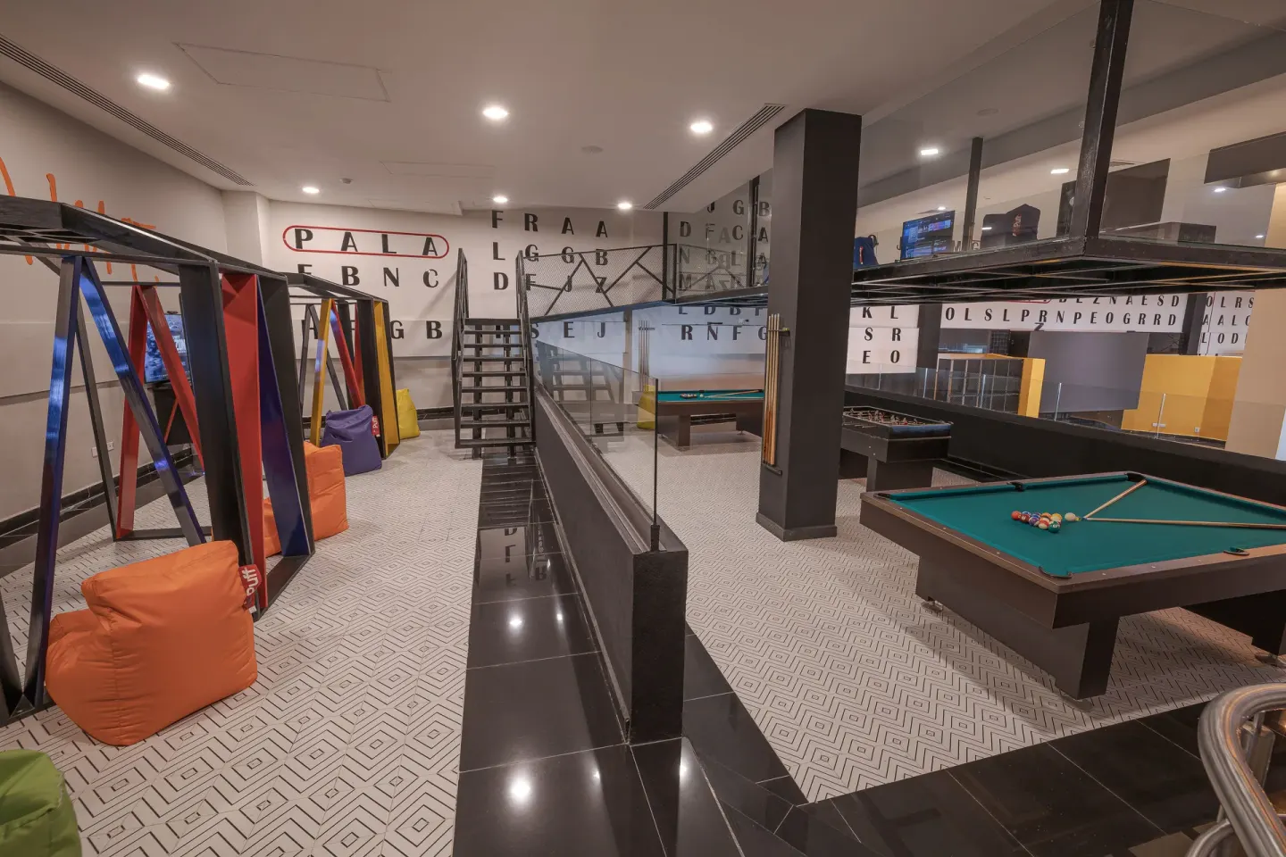 Pool tables and gaming booths in the teens club at Sensira Resort & Spa Riviera Maya.