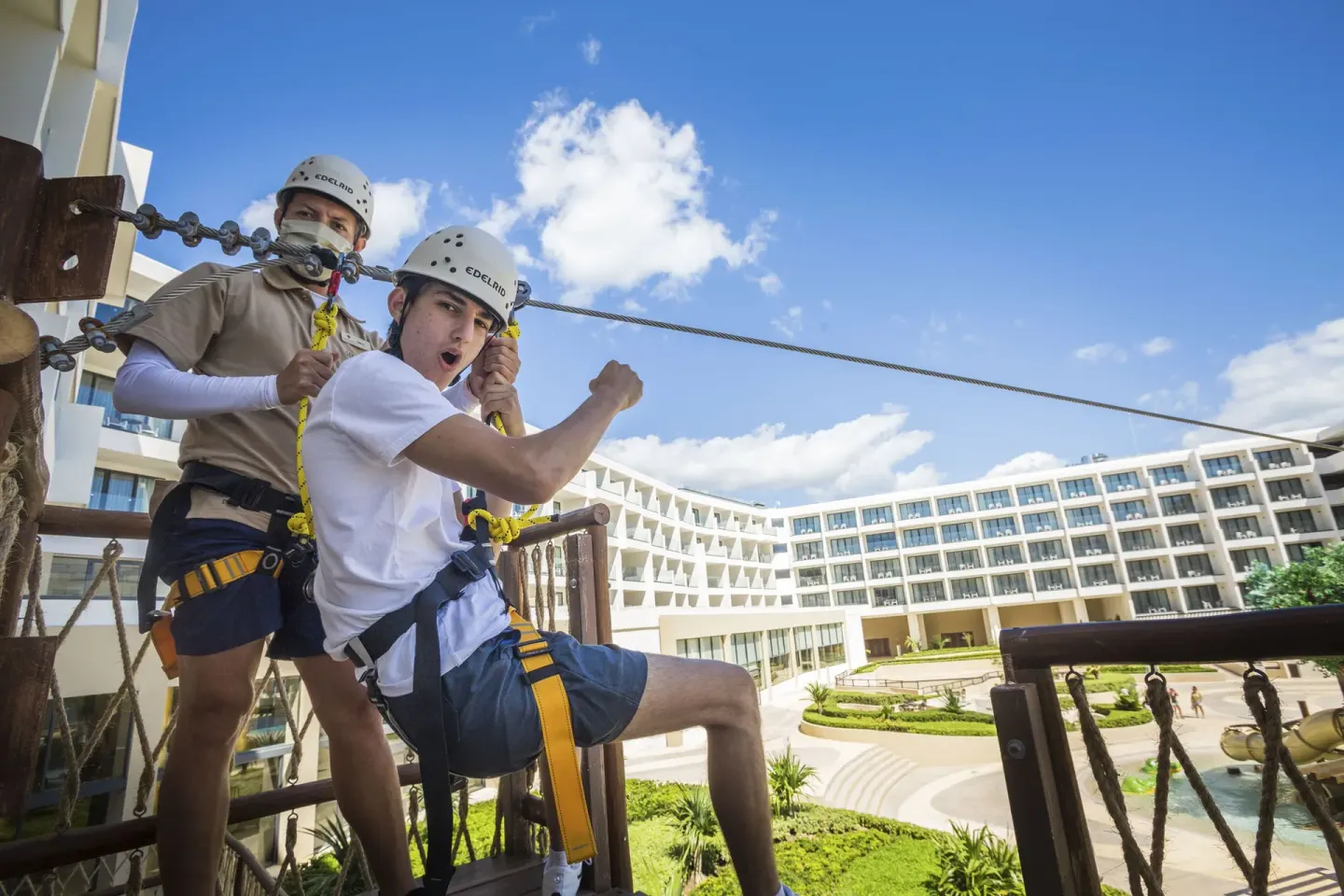 Zipline platform with harnessed guests above the courtyard at Sensira Resort & Spa Riviera Maya.