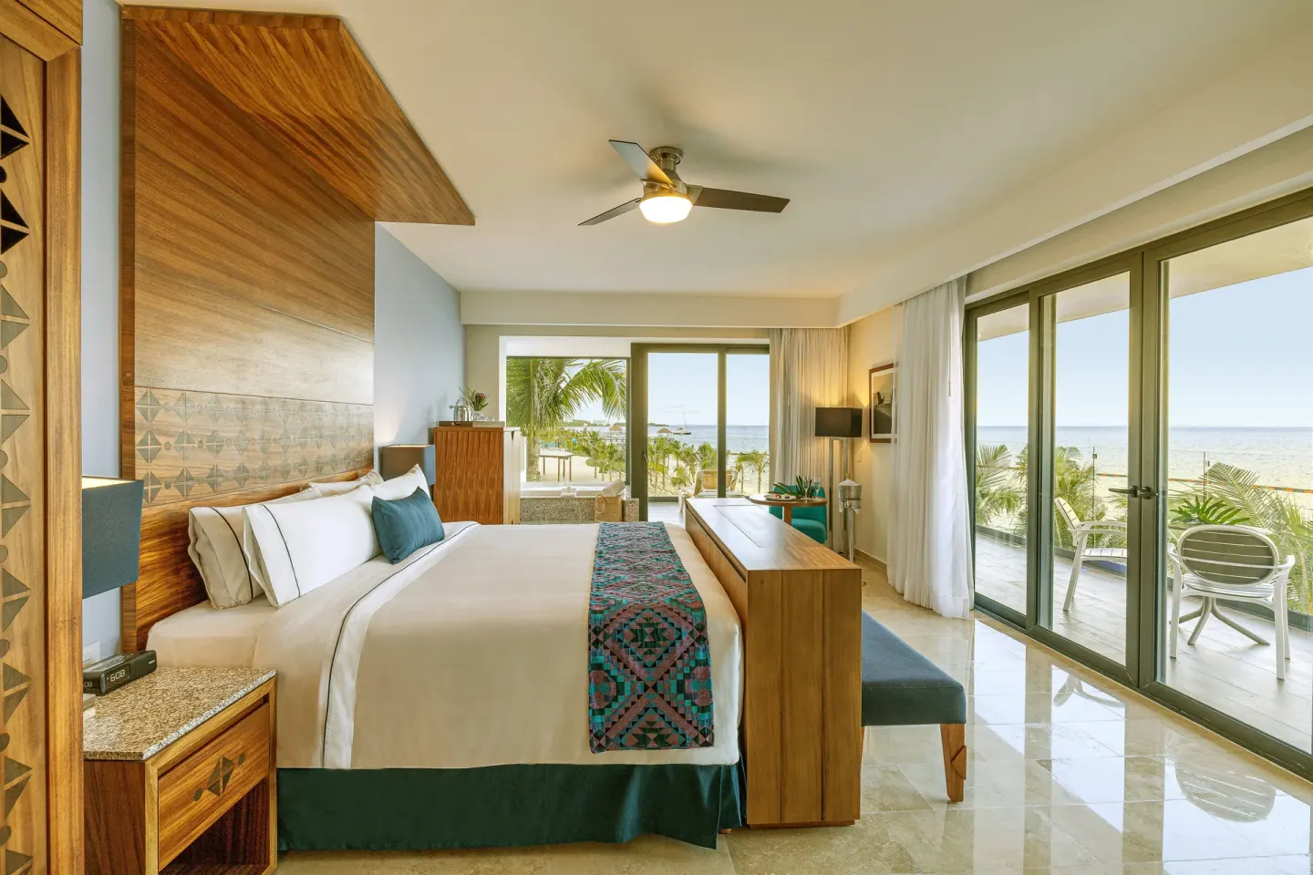 Ruby Suite king bed and oceanfront balcony at Sensira Resort & Spa Riviera Maya.