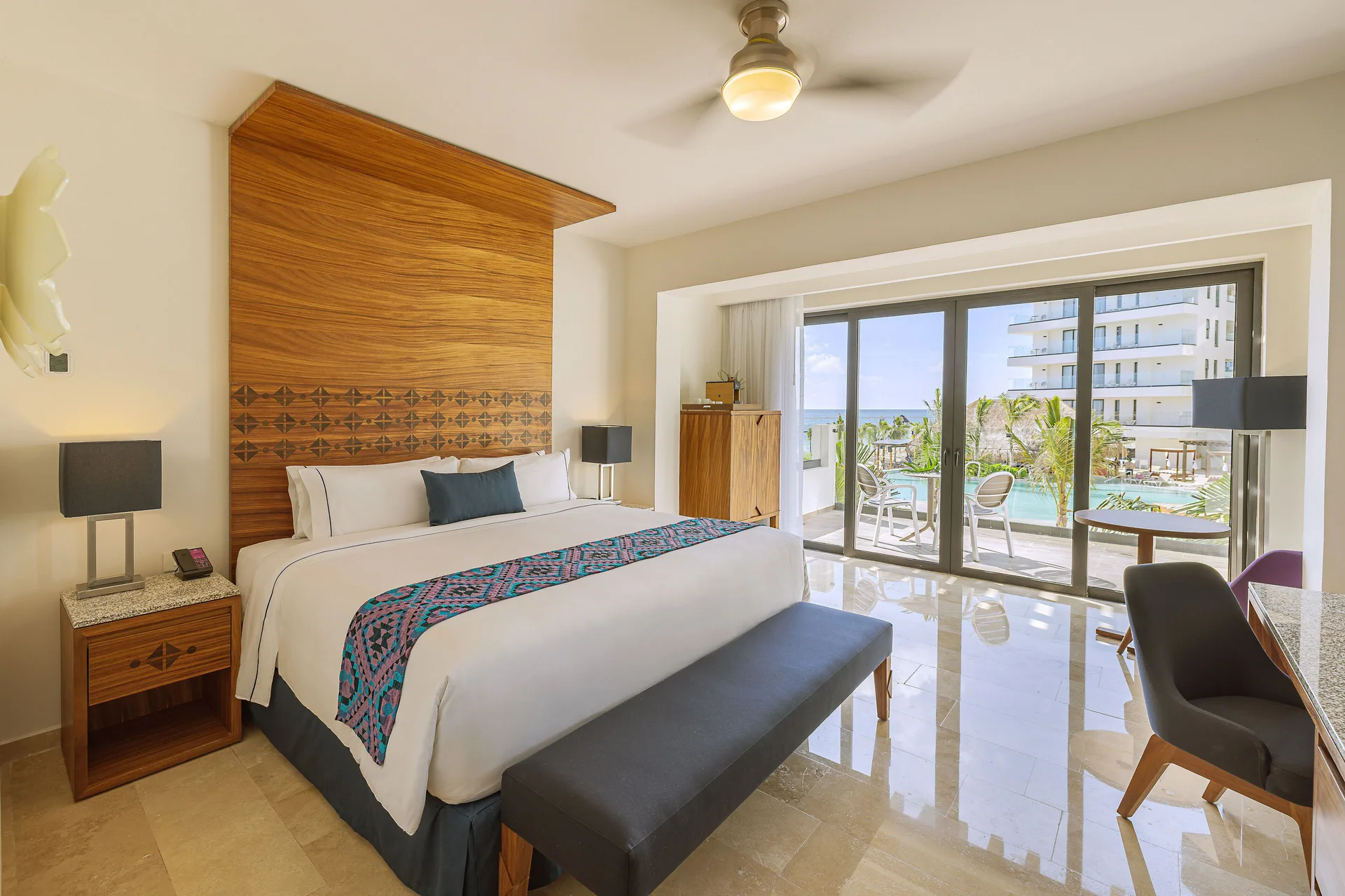 Sapphire Room king bed with balcony and pool view at Sensira Resort & Spa Riviera Maya.