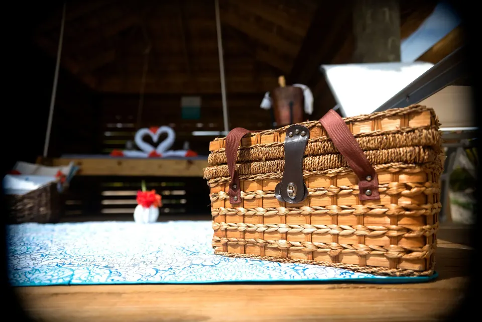 Woven picnic basket close-up on a mat inside a beachfront cabana at Serenity At Coconut Bay