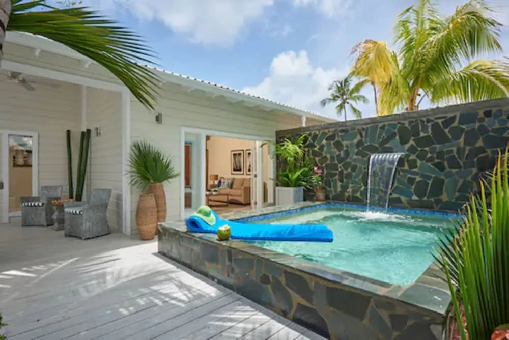 Deck with private pool and waterfall feature outside suite at Serenity At Coconut Bay