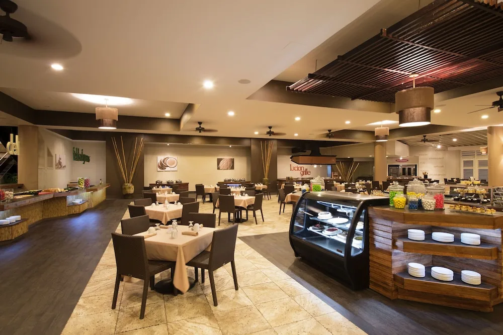 Buffet dining area with display cases and seating at Serenity At Coconut Bay
