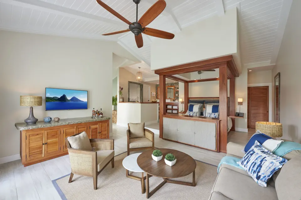 Spacious Grande Plunge Pool Butler Suite living area with four-poster bed at Serenity At Coconut Bay