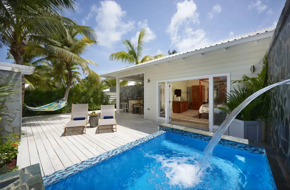 Private plunge pool terrace with loungers and waterfall spout at Serenity At Coconut Bay