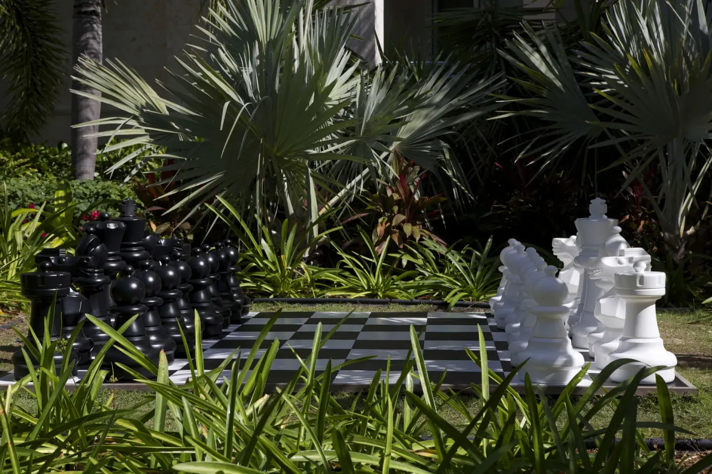Oversized outdoor chessboard among tropical plants at Seven Stars Resort & Spa.