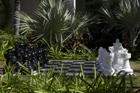 Oversized outdoor chessboard among tropical plants at Seven Stars Resort & Spa.