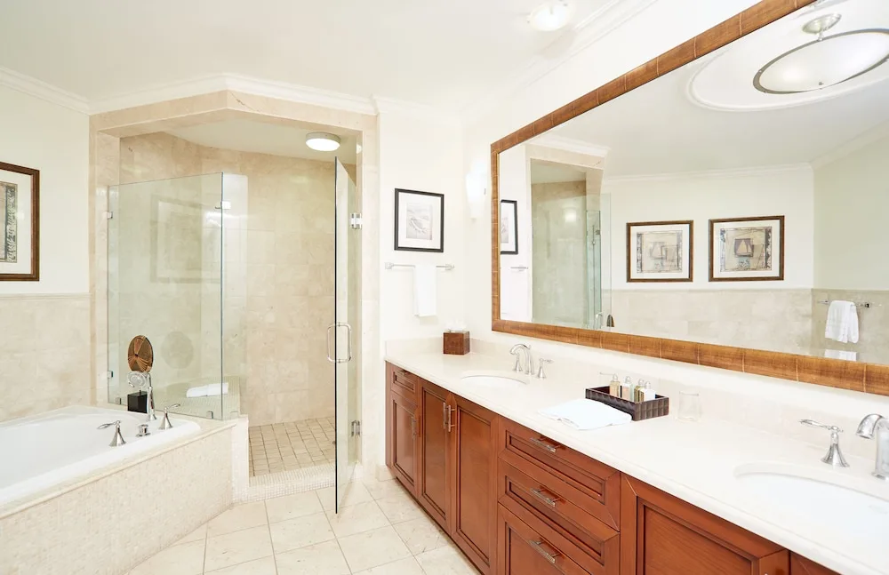 Guest bathroom with tub, glass shower, and double vanity at Seven Stars Resort & Spa.