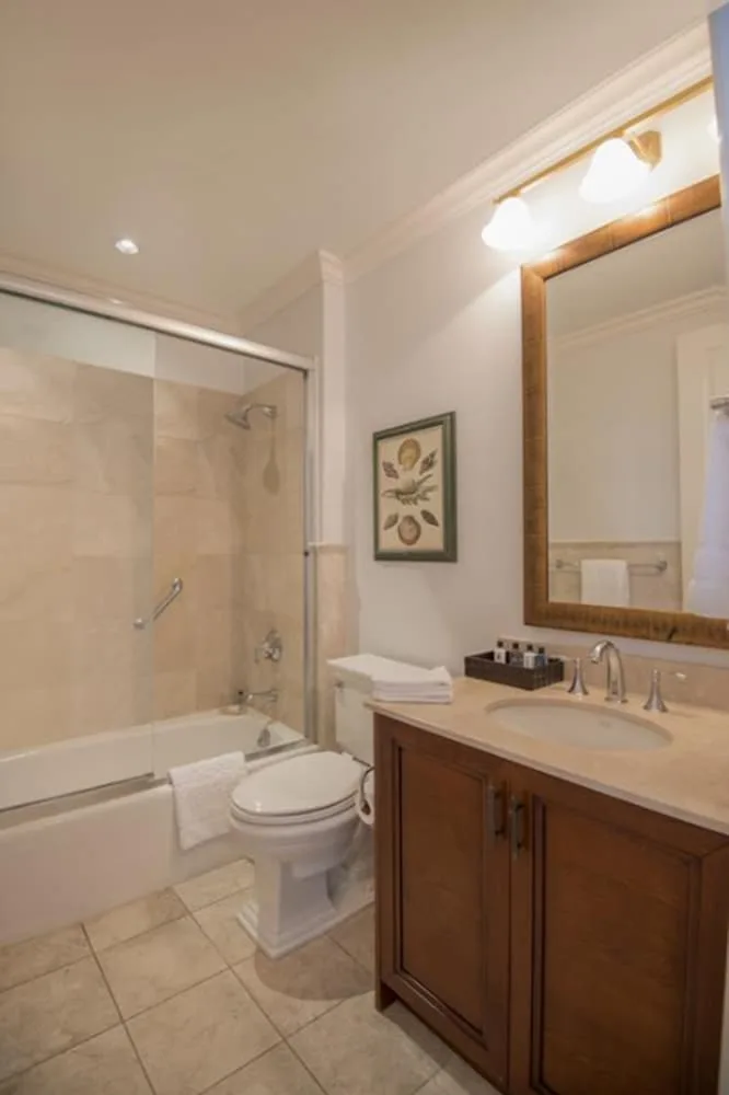 Guest bathroom with vanity, toilet, and tub-shower combination at Seven Stars Resort & Spa.