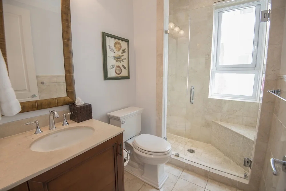 Bathroom with vanity, toilet, and glass walk-in shower at Seven Stars Resort & Spa.