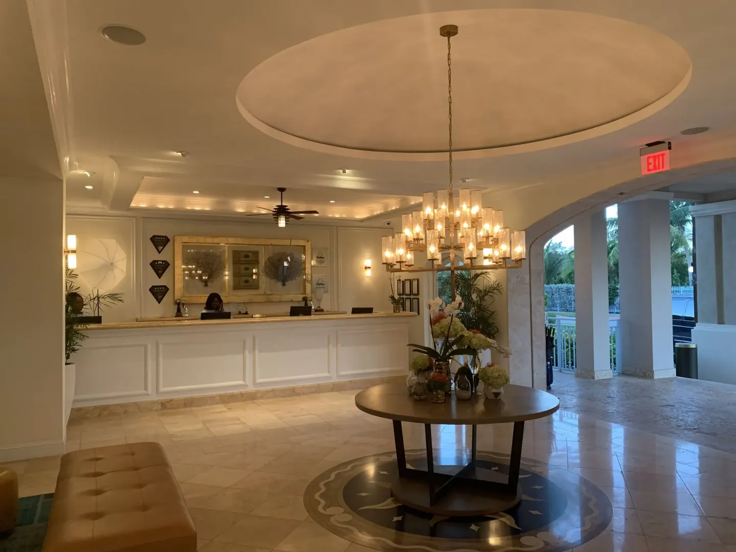 Lobby reception desk with chandelier and floral table at Seven Stars Resort & Spa.