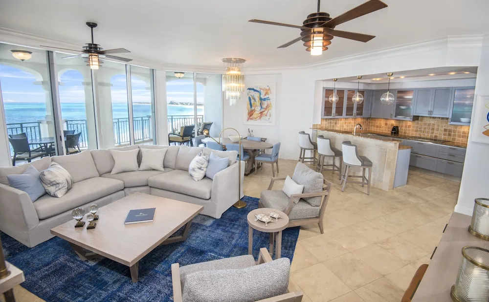 Ocean-view suite living area with sofa, dining table, and kitchen at Seven Stars Resort & Spa.