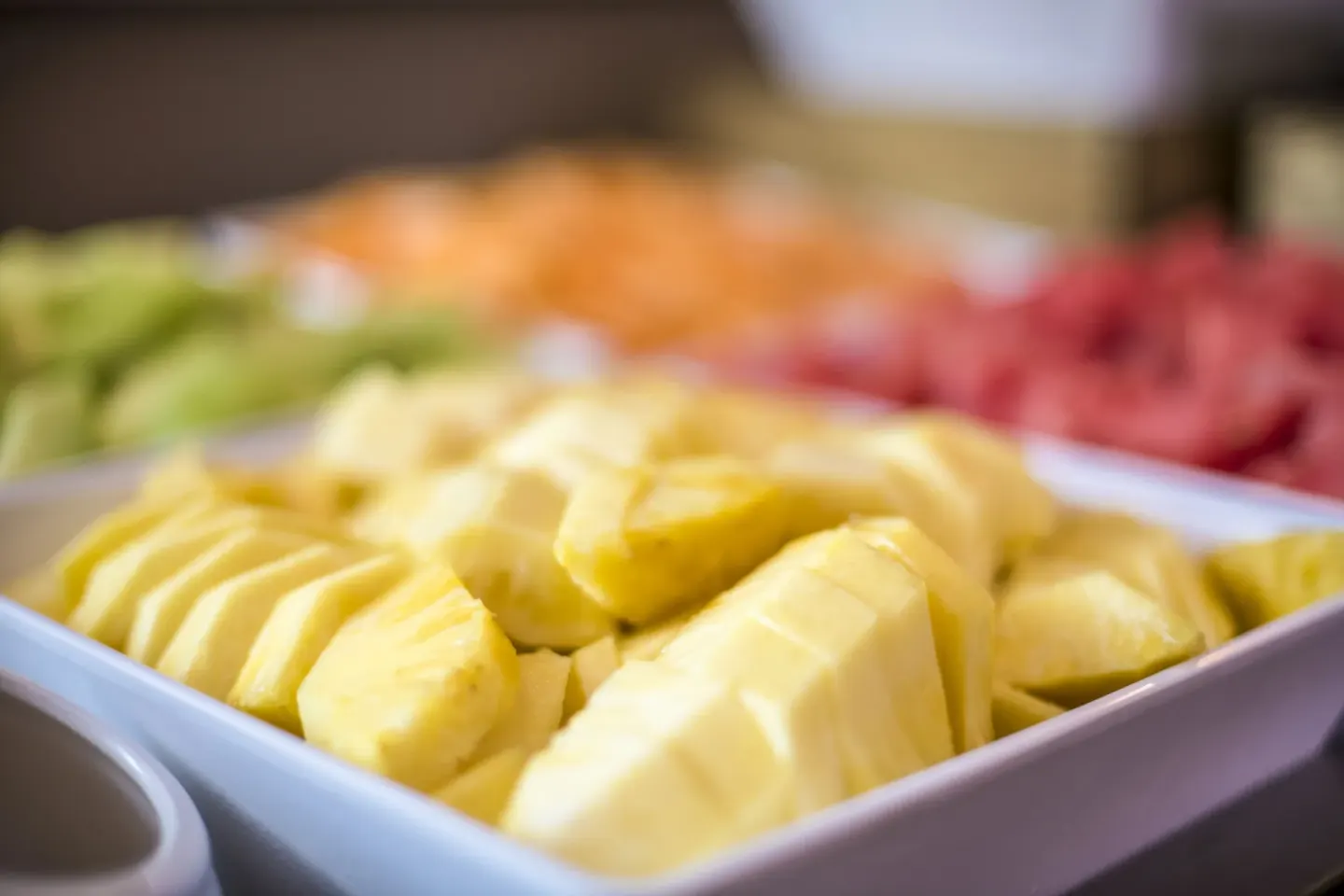 Tray of sliced pineapple and fruit on a buffet at Seven Stars Resort & Spa.