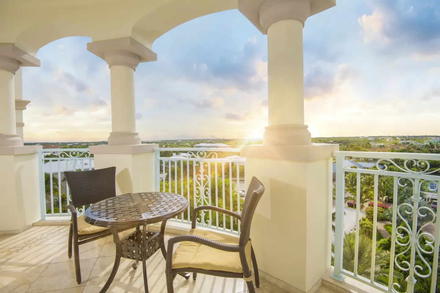 1-Bedroom Suite Island View balcony with table and chairs at Seven Stars Resort & Spa.