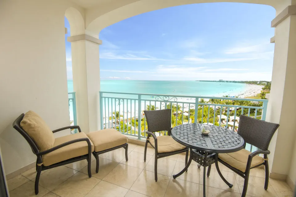 Junior Suite Oceanfront balcony with seating and sea view at Seven Stars Resort & Spa.