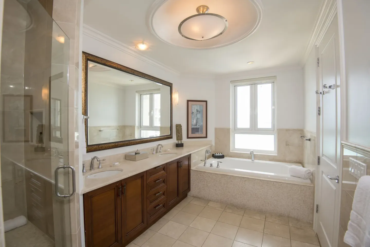 Junior Suite Oceanfront bathroom with tub and glass shower at Seven Stars Resort & Spa.
