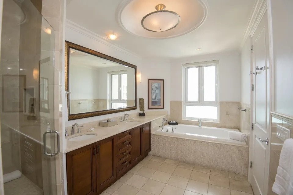 Junior Suite Oceanfront bathroom with tub and glass shower at Seven Stars Resort & Spa.