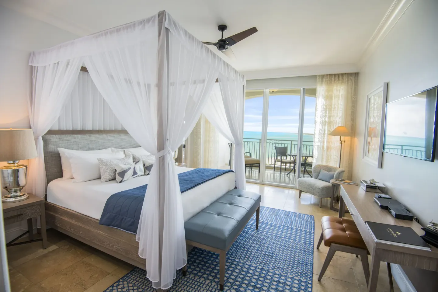 Junior Suite Oceanfront king canopy bed and balcony at Seven Stars Resort & Spa.