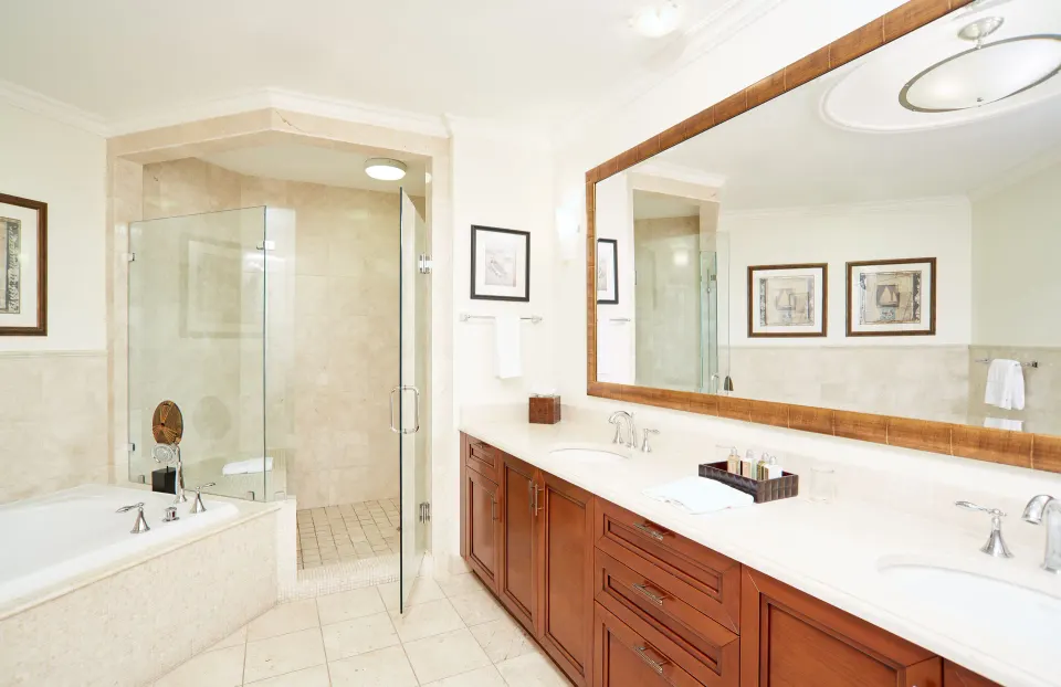 One Bedroom Island View suite bathroom with tub, shower, and double vanity at Seven Stars Resort & Spa.