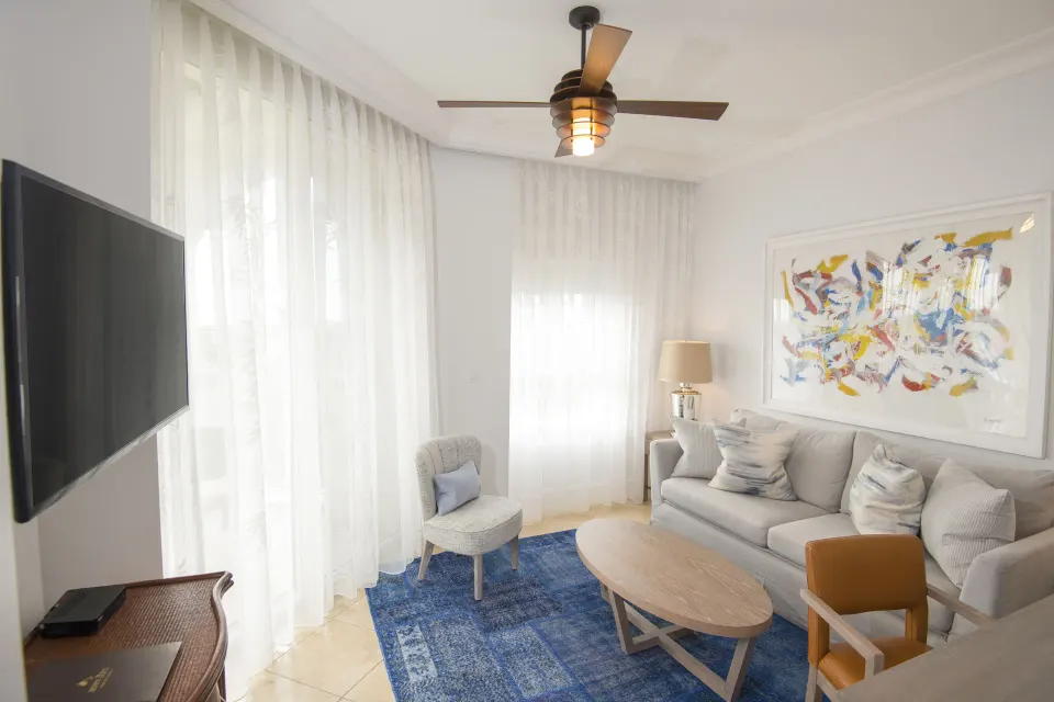 One Bedroom Island View suite living room with sofa and TV at Seven Stars Resort & Spa.