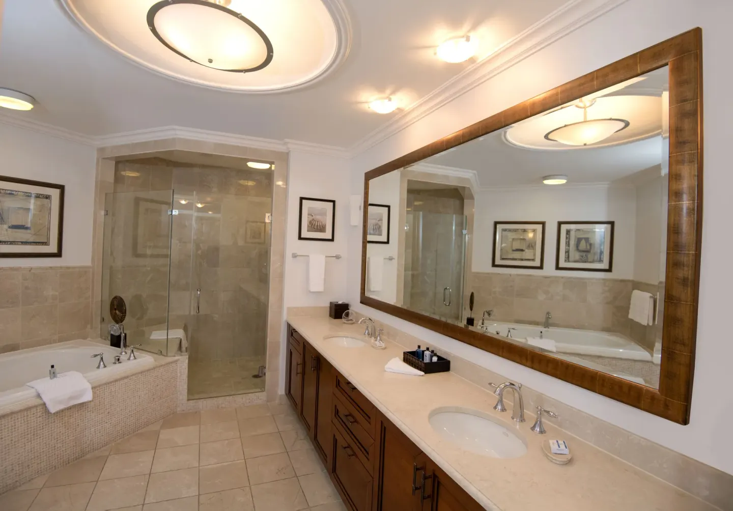Ocean View Two Bedroom Suite bathroom with tub and glass shower at Seven Stars Resort & Spa.
