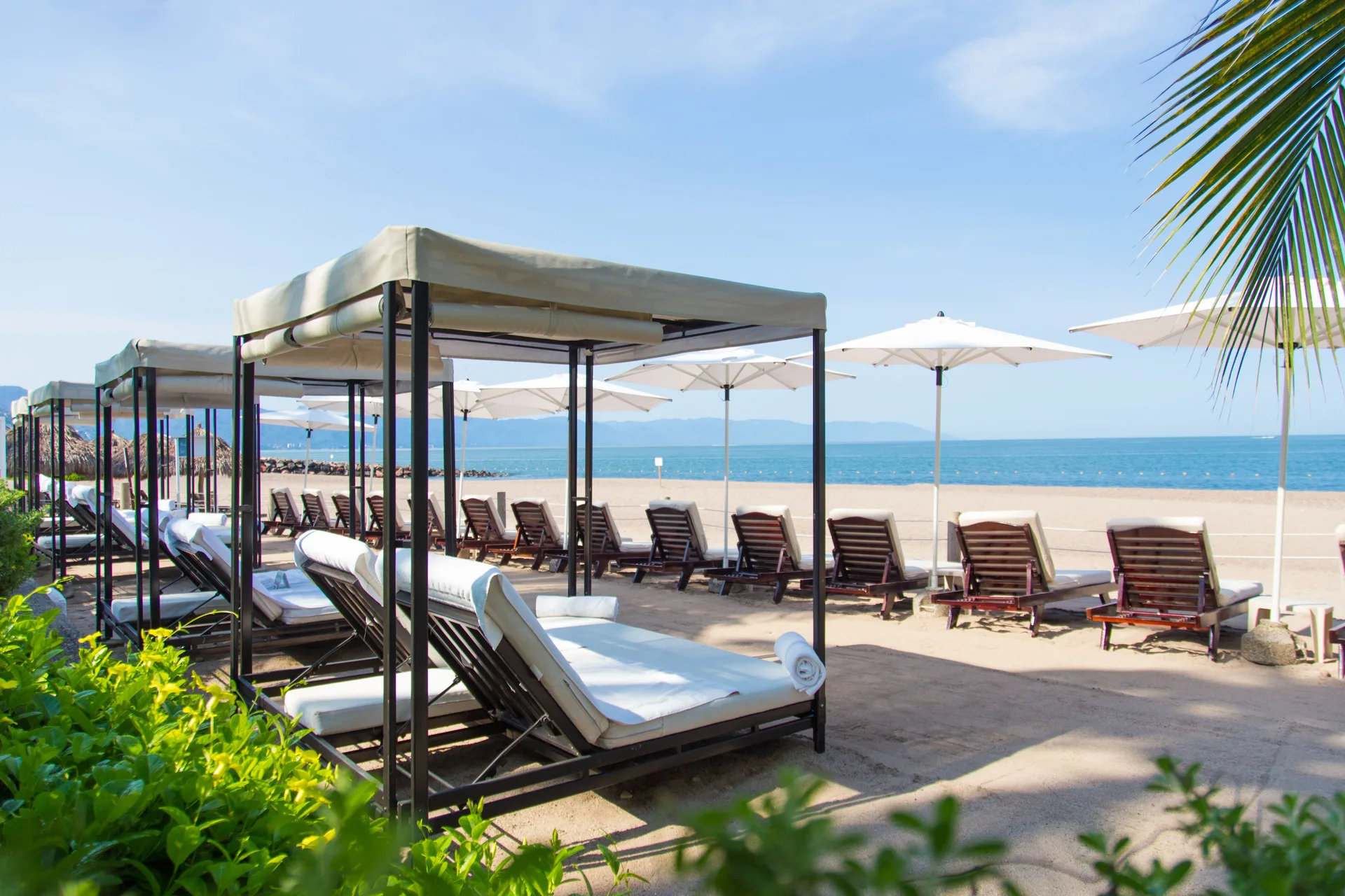 Beach loungers and cabanas facing the ocean at Sheraton Buganvilias Puerto Vallarta.