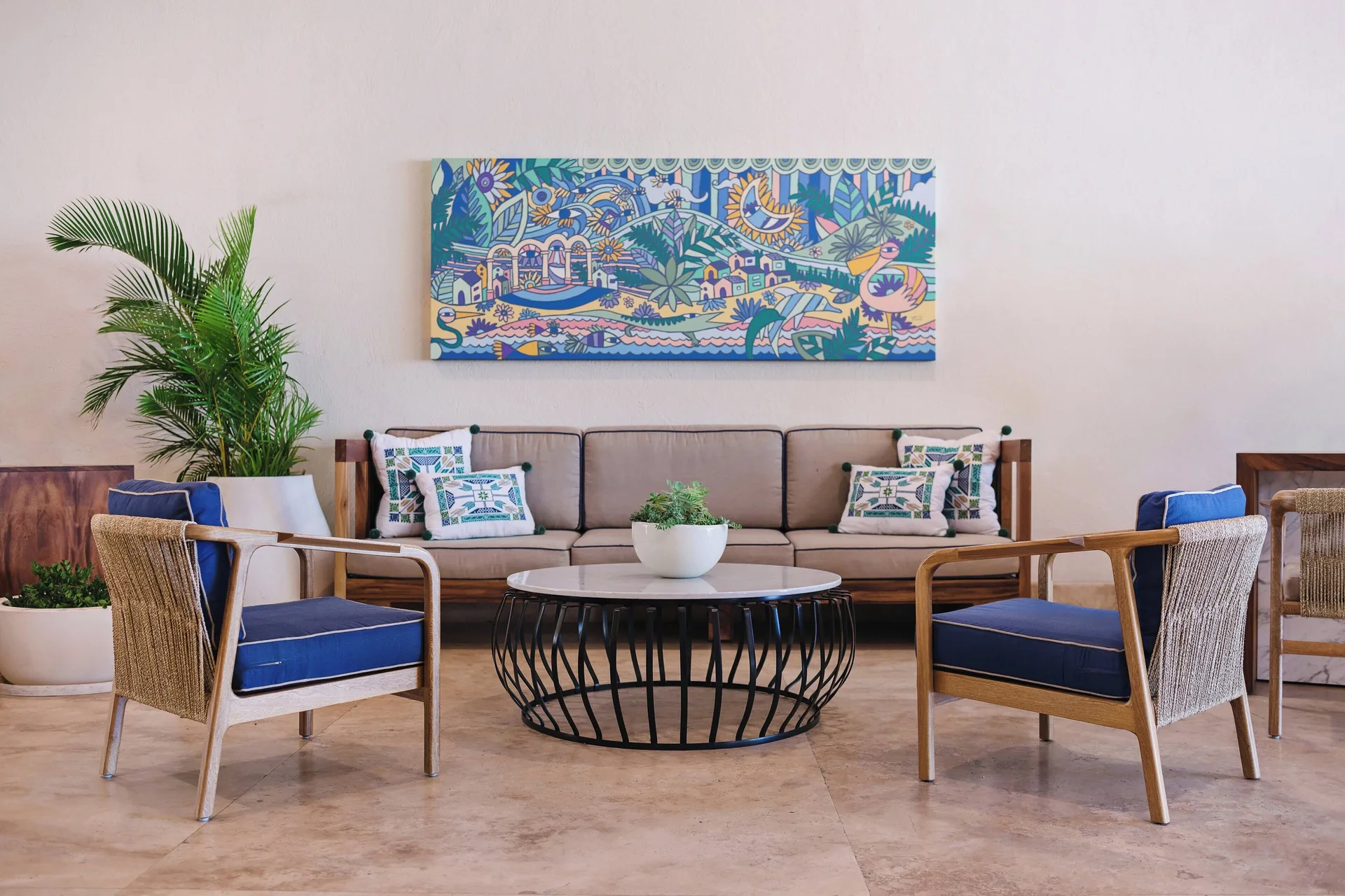 Colorful lobby seating area with blue chairs and wall art at Sheraton Buganvilias Puerto Vallarta.