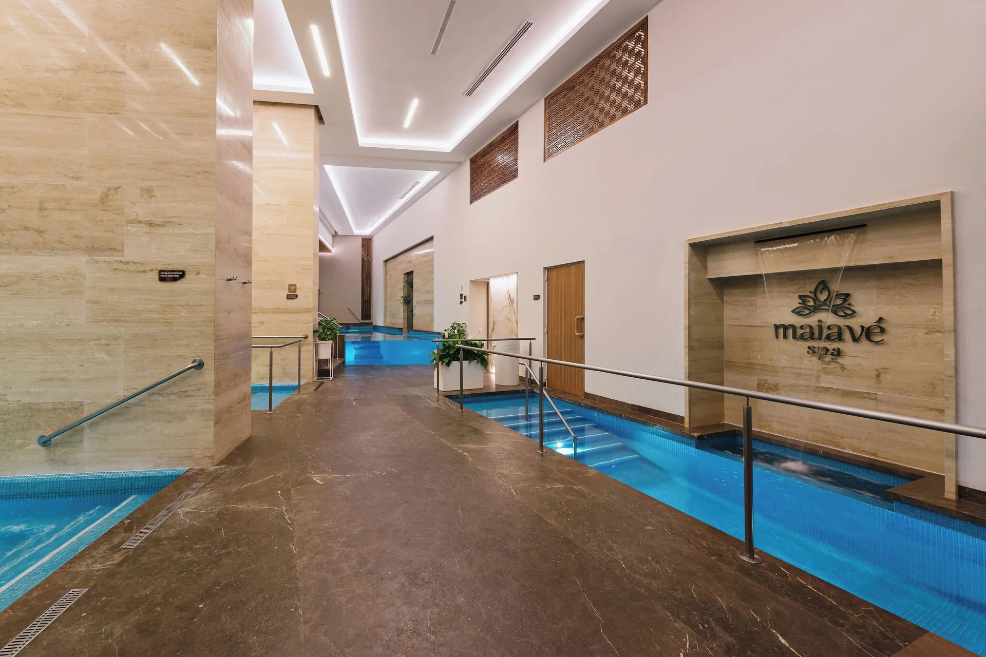 Indoor spa hydrotherapy corridor with blue pools at Sheraton Buganvilias Puerto Vallarta.