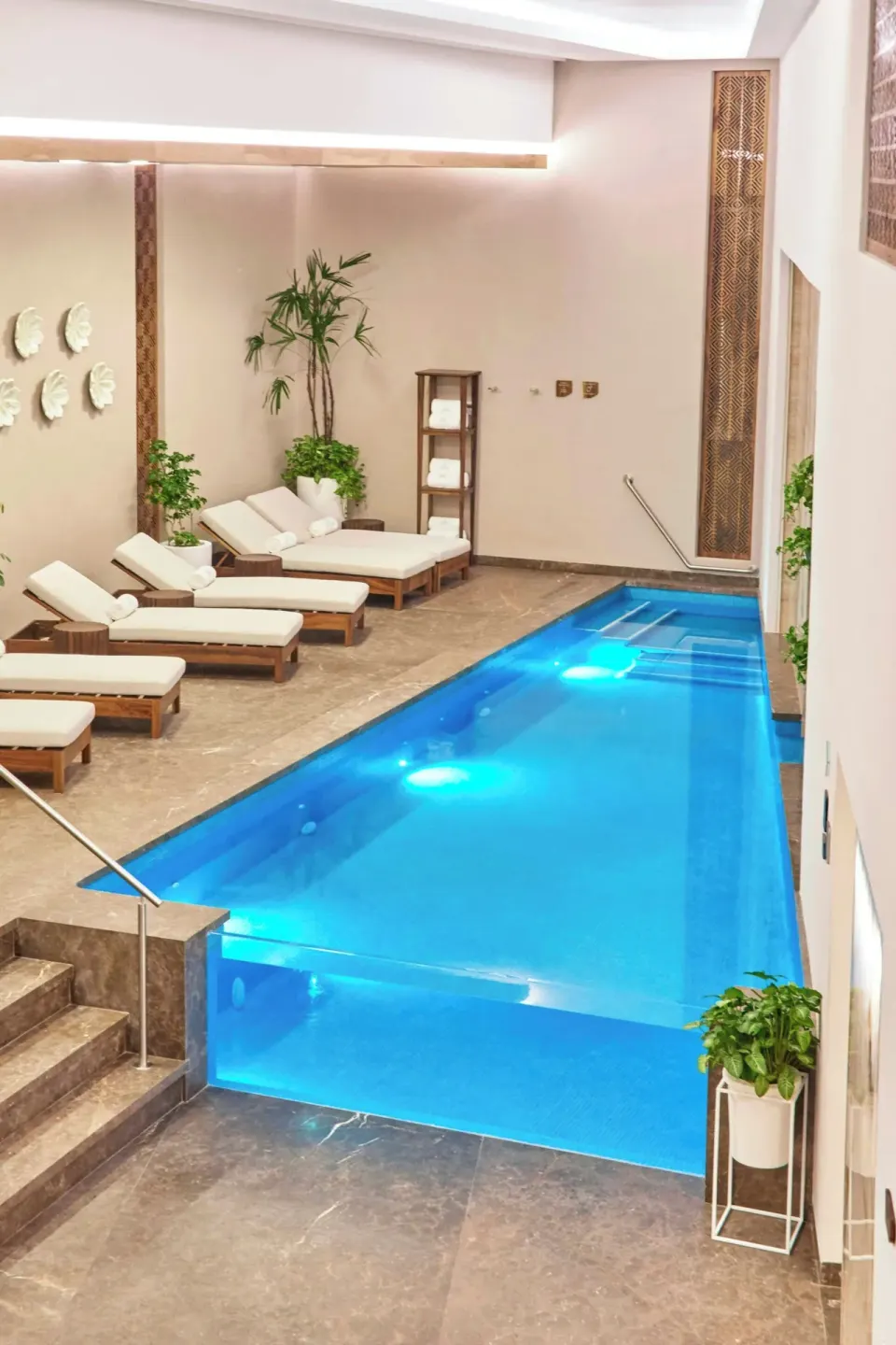 Indoor spa pool with loungers and plants at Sheraton Buganvilias Puerto Vallarta.