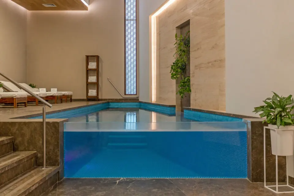 Indoor spa pool with loungers and plants at Sheraton Buganvilias Puerto Vallarta.