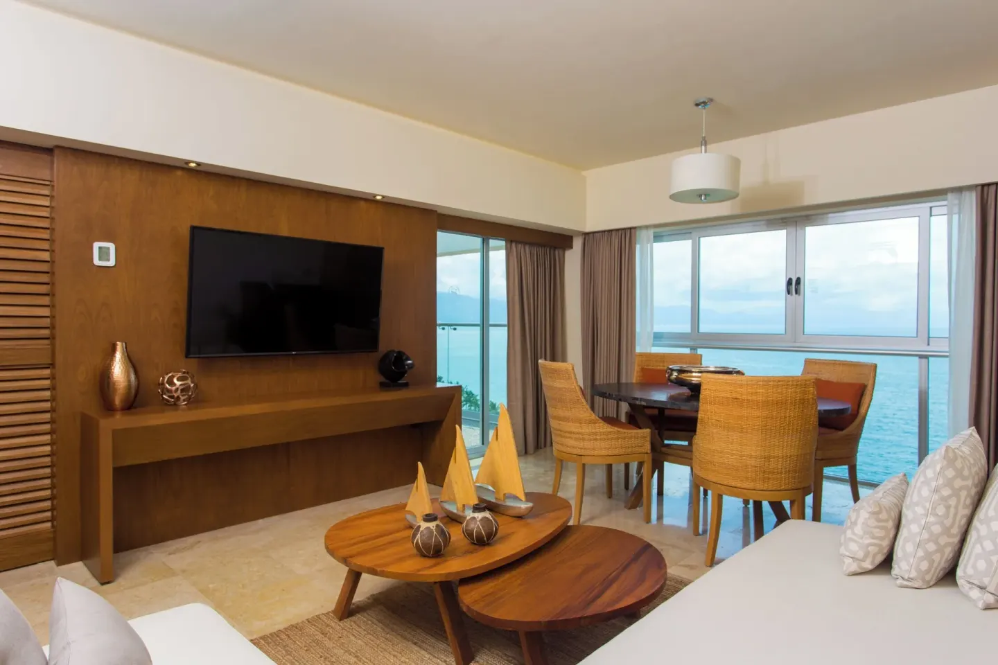 Suite living and dining area with ocean windows at Sheraton Buganvilias Puerto Vallarta.